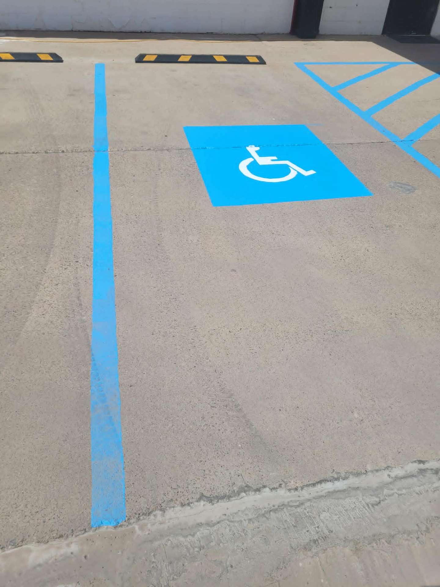 Freshly painted ADA accessible parking stripes and handicap symbol